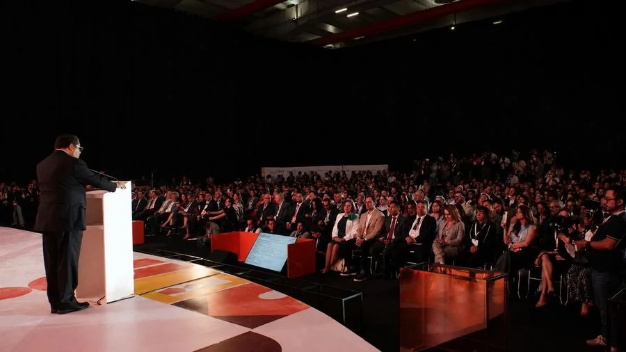 Speaker dirigiéndose al público desde el podio